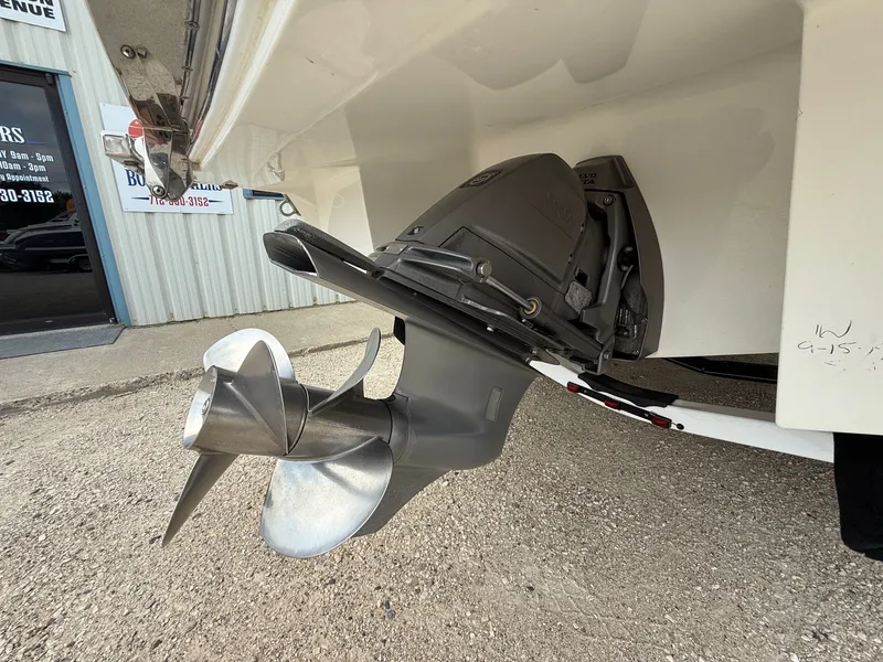 Slide: The Image of 2014 Cobalt 24SD boat with Volvo Penta outdrive and propeller, parked outside a building. - 7