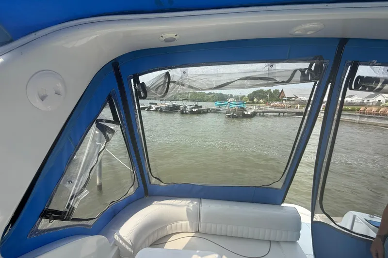 Slide: The Image of Interior view of 2001 Cruisers Yachts 2870 Express, overlooking marina through clear windows. - 13
