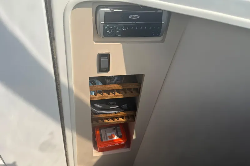 Slide: The Image of 2001 Cruisers Yachts 2870 Express interior storage with stereo system and organized compartments. - 5