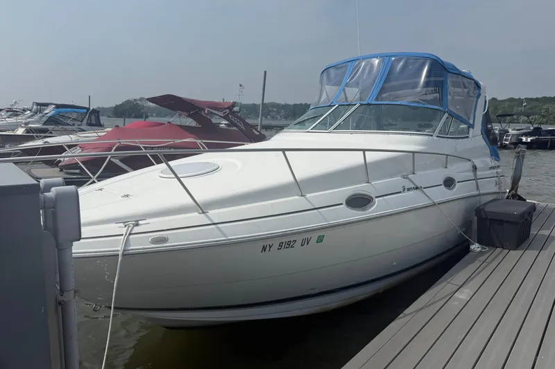 Slide: The Image of 2001 Cruisers Yachts 2870 Express docked at marina with blue canopy. - 1