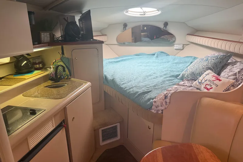 Slide: The Image of 2001 Cruisers Yachts 2870 Express cabin interior with cozy bed and kitchenette. - 10