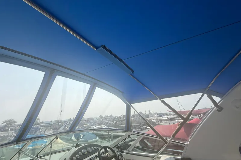 Slide: The Image of Interior view of 2001 Cruisers Yachts 2870 Express with blue canopy and dashboard. - 14