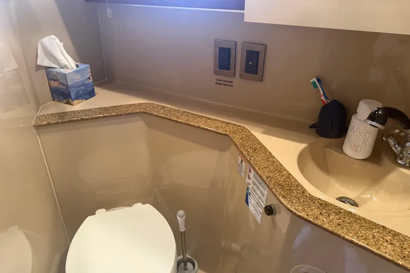 Slide: The Image of 2001 Cruisers Yachts 2870 Express bathroom with sink, toilet, and countertop. - 8