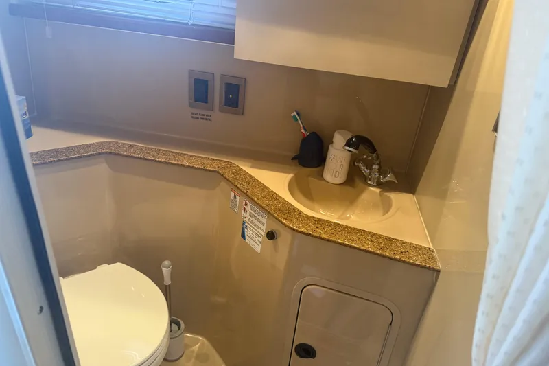 Slide: The Image of 2001 Cruisers Yachts 2870 Express bathroom with sink, toilet, and countertop. - 9