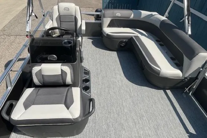 Slide: The Image of 2026 Sun Tracker Bass Buggy 16 XL Select pontoon boat interior with seating and steering console. - 11