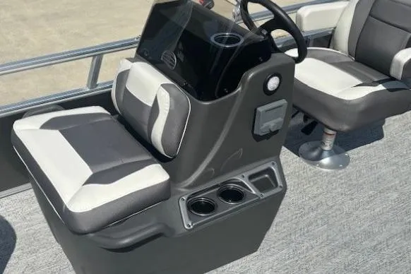 Slide: The Image of 2026 Sun Tracker Bass Buggy 16 XL Select boat interior with steering console and seating. - 12