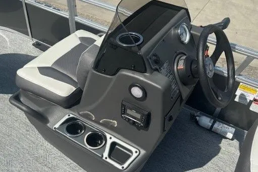 Slide: The Image of 2026 Sun Tracker Bass Buggy 16 XL Select boat console with steering wheel and cup holders. - 14