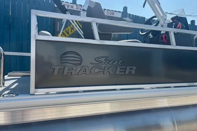 Slide: The Image of 2026 Sun Tracker Bass Buggy 16 XL Select pontoon boat, side view with logo. - 2