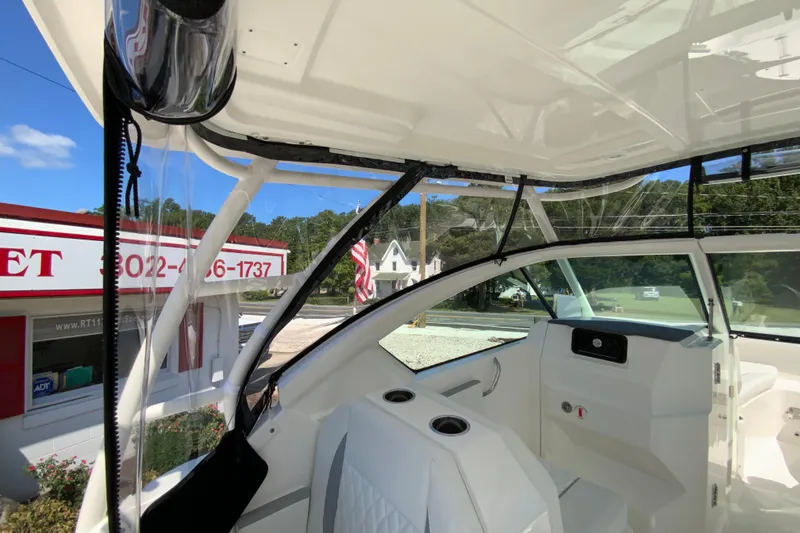 Slide: The Image of 2026 Pursuit DC 266 Dual Console boat interior with modern seating and dashboard. - 12