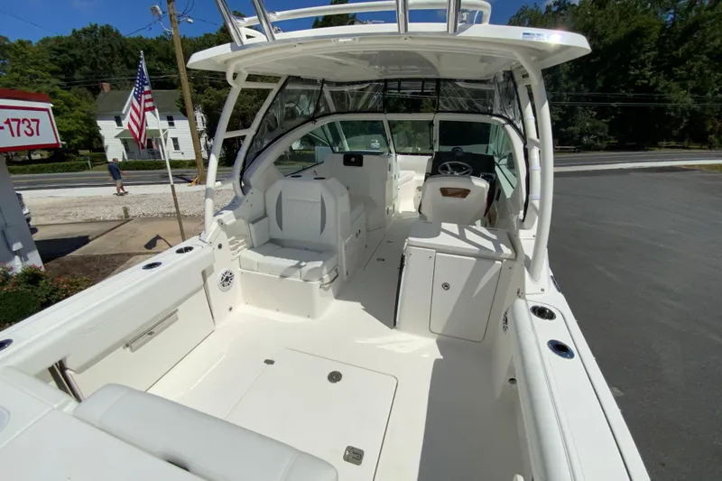 Slide: The Image of 2026 Pursuit DC 266 Dual Console boat interior with seating and steering wheel. - 16