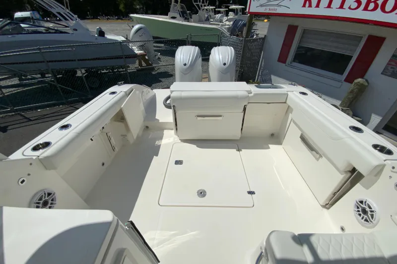 Slide: The Image of 2026 Pursuit DC 266 Dual Console boat interior with seating and storage compartments. - 22