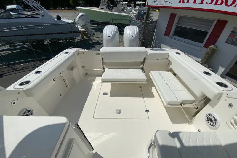 Slide: The Image of 2026 Pursuit DC 266 Dual Console boat interior with white seating and spacious layout. - 23