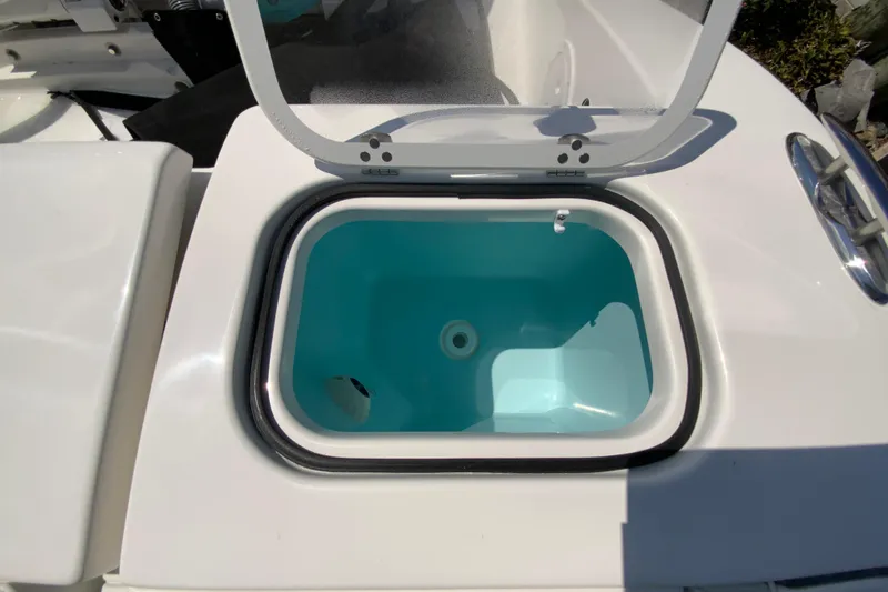 Slide: The Image of Livewell compartment on 2026 Pursuit DC 266 Dual Console boat, open lid view. - 26