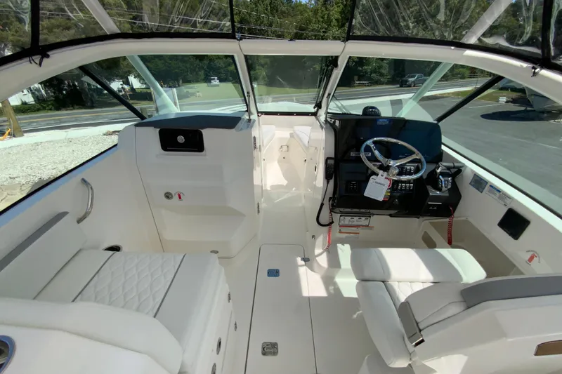 Slide: The Image of 2026 Pursuit DC 266 Dual Console boat interior with steering wheel and seating. - 27