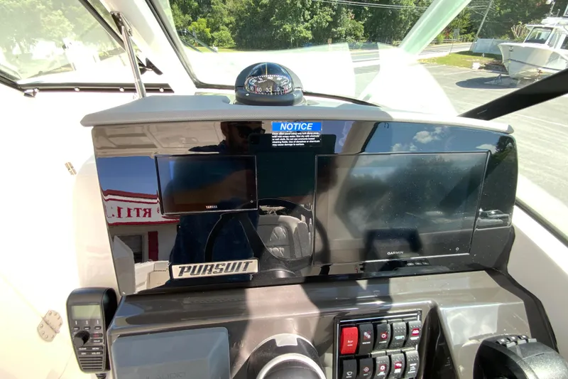 Slide: The Image of Helm of 2026 Pursuit DC 266 Dual Console with Garmin display and controls. - 29