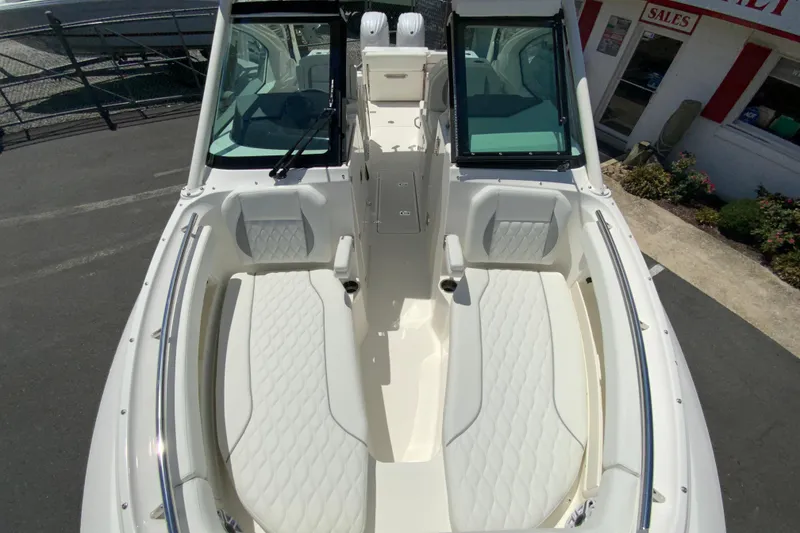 Slide: The Image of 2026 Pursuit DC 266 Dual Console boat interior with white seating and sleek design. - 39
