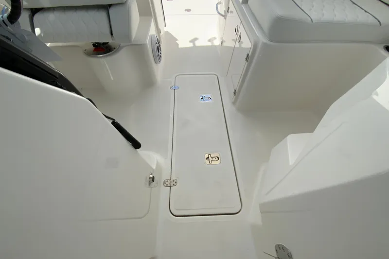 Slide: The Image of 2026 Pursuit DC 266 Dual Console interior with white seating and storage compartments. - 40