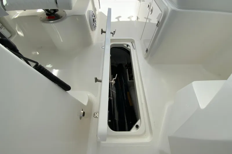 Slide: The Image of 2026 Pursuit DC 266 Dual Console boat interior with open storage compartment. - 41