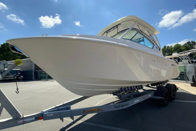 Slide: The Image of 2026 Pursuit DC 266 Dual Console boat on trailer under clear blue sky. - 6