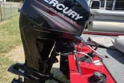 Slide: The Image of 2017 Bass Tracker Pro Team 175 with Mercury outboard motor, parked on grass. - 7