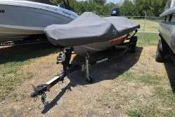 The Image of 2017 Bass Tracker Pro Team 175 boat covered and parked on grass. - 1