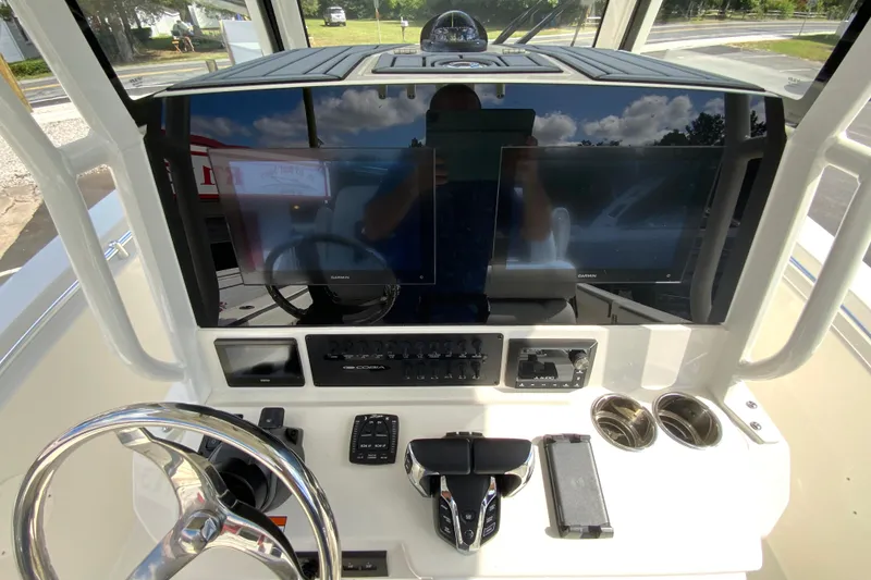 Slide: The Image of 2026 Cobia 265 Open Center Console dashboard with modern controls and dual displays. - 13