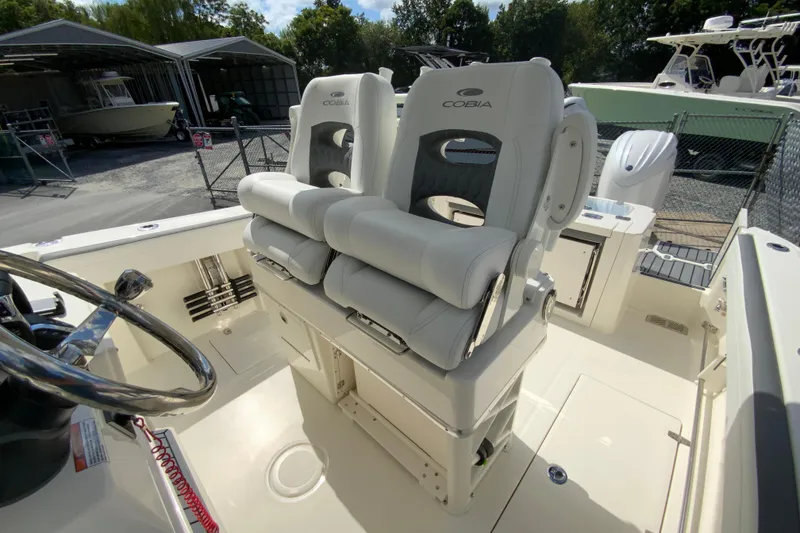 Slide: The Image of 2026 Cobia 265 Open Center Console boat with dual cushioned seats. - 14