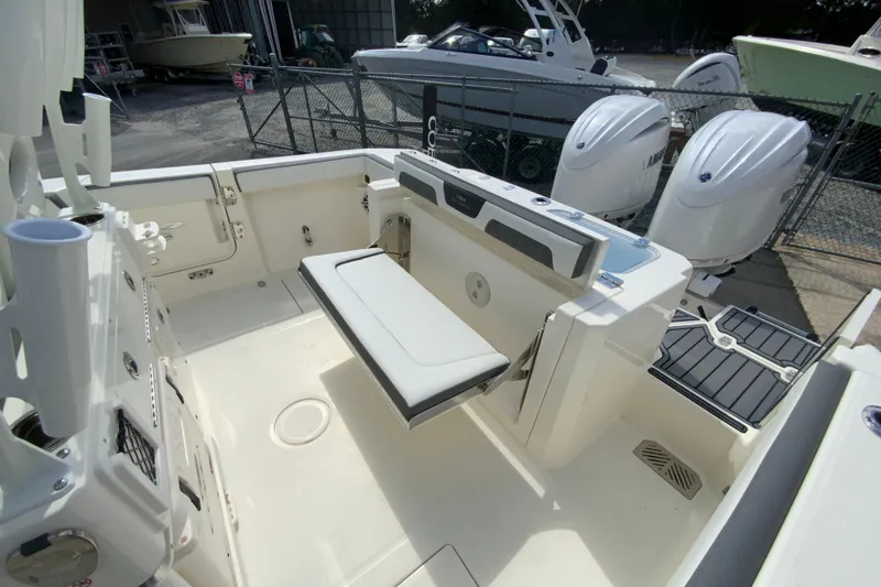 Slide: The Image of 2026 Cobia 265 Open Center Console boat interior with seating and dual engines. - 17