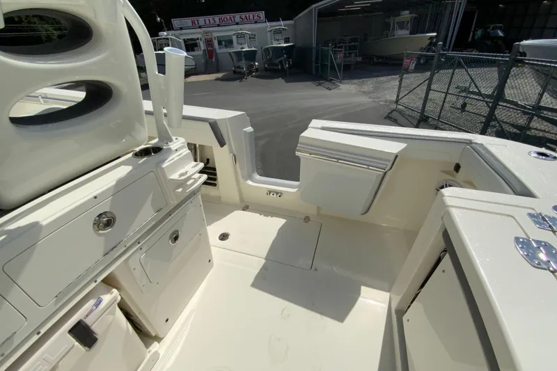 Slide: The Image of 2026 Cobia 265 Open Center Console boat interior at dealership. - 19