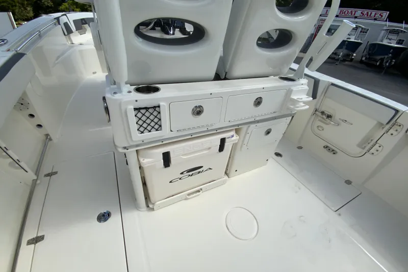 Slide: The Image of 2026 Cobia 265 Open Center Console boat interior with storage compartments and seating. - 20