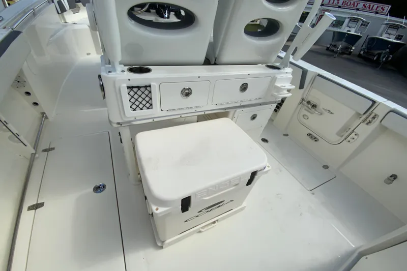 Slide: The Image of 2026 Cobia 265 Open Center Console boat interior with storage and seating. - 21