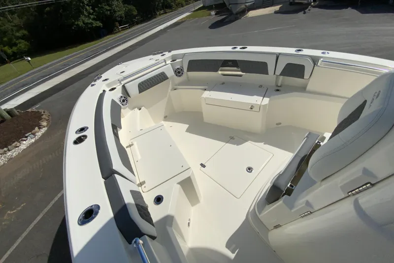 Slide: The Image of 2026 Cobia 265 Open Center Console boat interior with seating and storage compartments. - 23