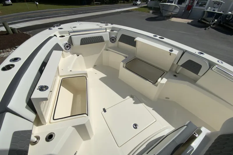 Slide: The Image of 2026 Cobia 265 Open Center Console boat interior with seating and storage compartments. - 24
