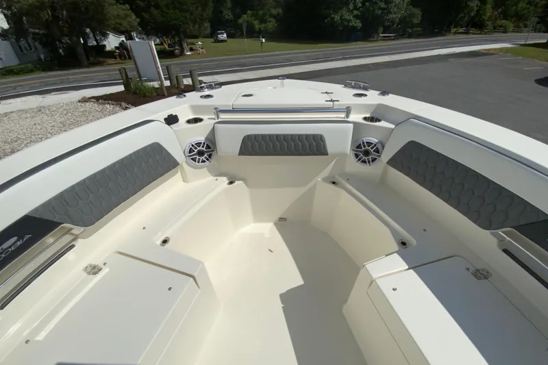 Slide: The Image of 2026 Cobia 265 Open Center Console boat interior with seating and speakers. - 26