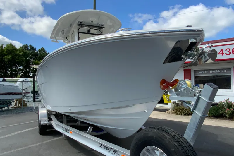 Slide: The Image of 2026 Cobia 265 Open Center Console boat on trailer, parked outdoors. - 3