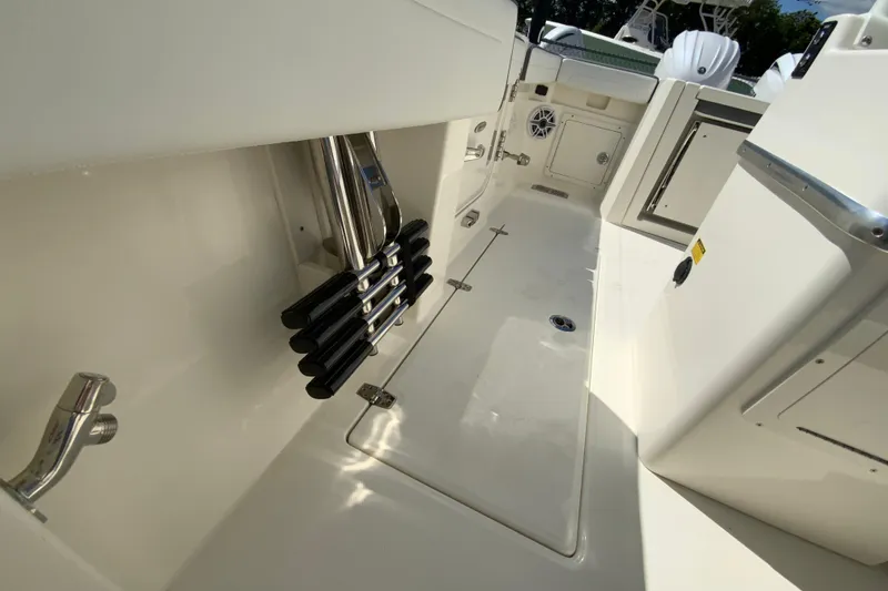 Slide: The Image of 2026 Cobia 265 Open Center Console interior with rod holders and storage compartments. - 36