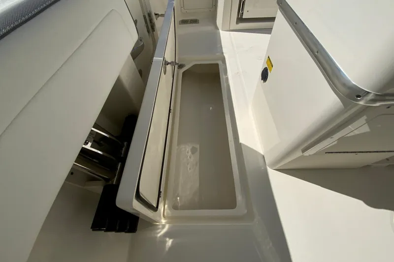 Slide: The Image of 2026 Cobia 265 Open Center Console boat interior storage compartment. - 37