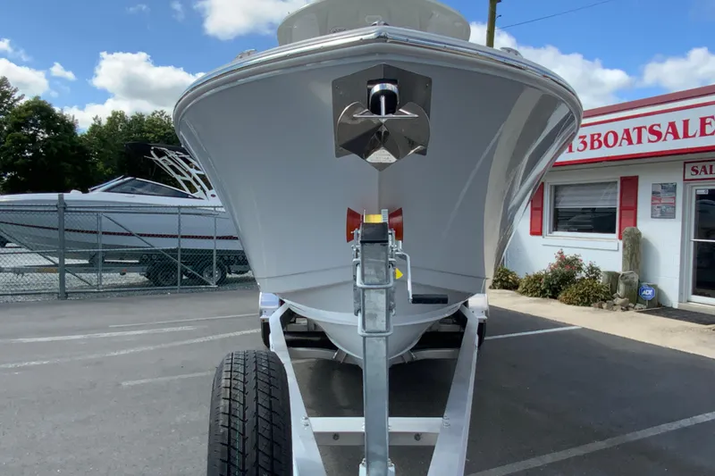 Slide: The Image of 2026 Cobia 265 Open Center Console boat on trailer at dealership. - 4