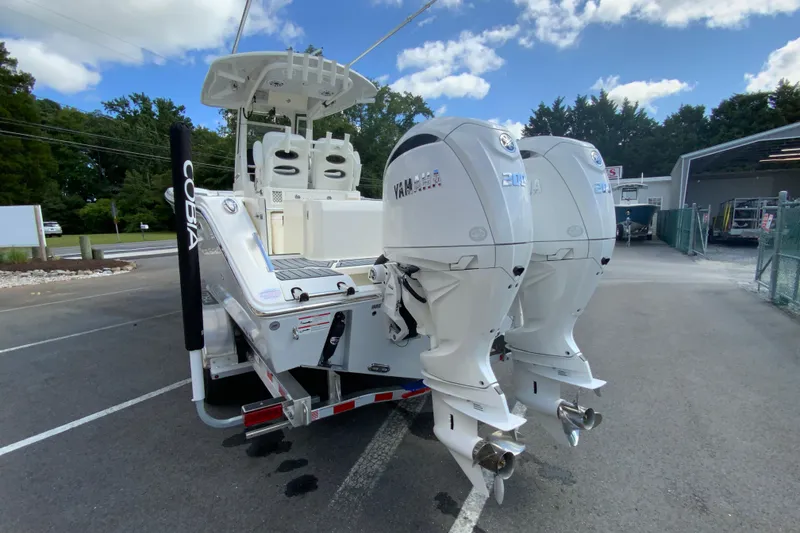 Slide: The Image of 2026 Cobia 265 Open Center Console boat with dual Yamaha outboard engines. - 8