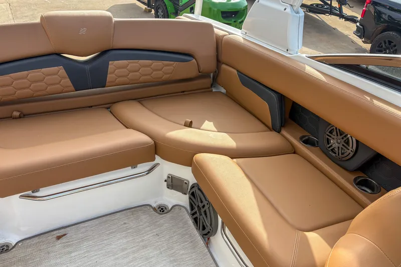 Slide: The Image of 2022 Four Winns HD5 boat interior with tan leather seating and built-in speakers. - 6