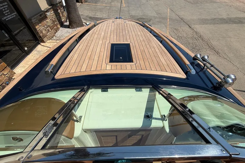 Slide: The Image of 2019 Chris-Craft Corsair 27 boat with sleek wooden deck and windshield. - 11