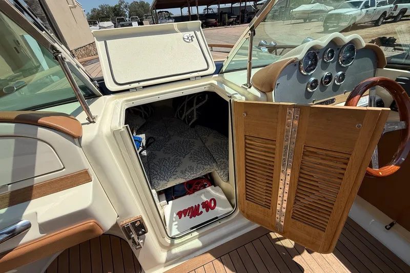 Slide: The Image of 2019 Chris-Craft Corsair 27 interior cabin with wooden door and dashboard view. - 12