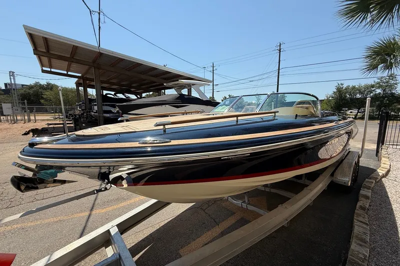 Slide: The Image of 2019 Chris-Craft Corsair 27 boat on trailer under sunny sky. - 3