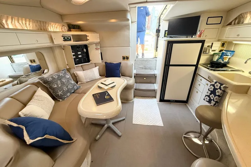 Slide: The Image of Interior of 1998 Sea Ray 400 Express Cruiser with cozy seating and modern amenities. - 13