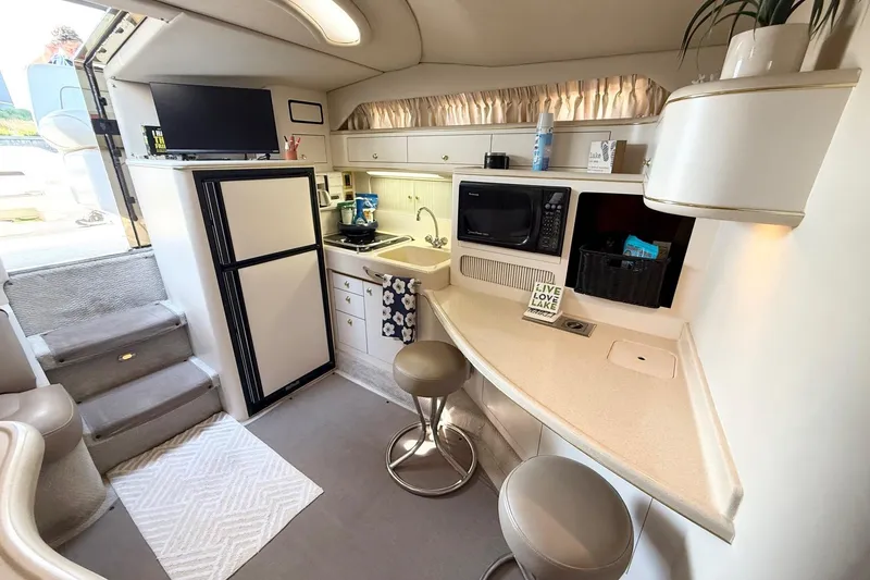 Slide: The Image of Interior of 1998 Sea Ray 400 Express Cruiser with kitchenette, seating, and modern amenities. - 14