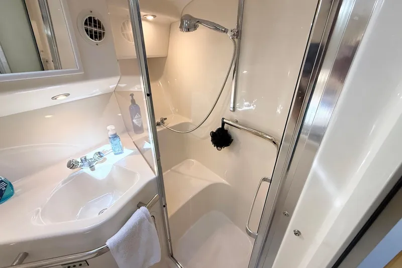 Slide: The Image of Bathroom interior of 1998 Sea Ray 400 Express Cruiser with shower and sink. - 19