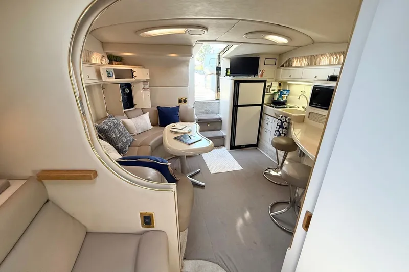 Slide: The Image of Interior of 1998 Sea Ray 400 Express Cruiser with modern kitchen and cozy seating area. - 20