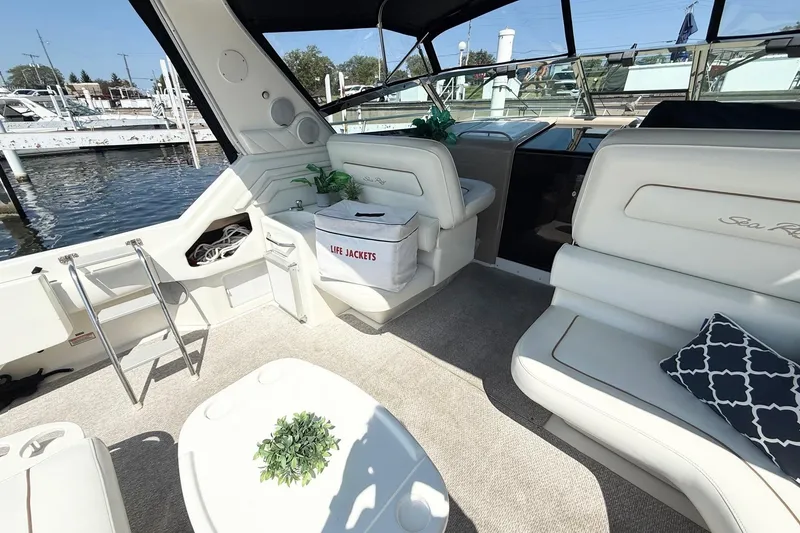 Slide: The Image of 1998 Sea Ray 400 Express Cruiser interior with seating, life jackets, and dock view. - 5