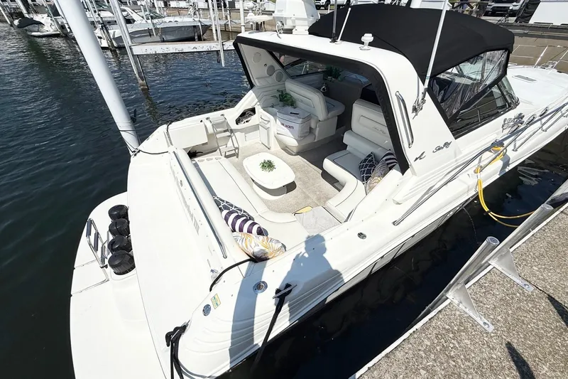 Slide: The Image of 1998 Sea Ray 400 Express Cruiser docked, featuring spacious seating and sleek design. - 6
