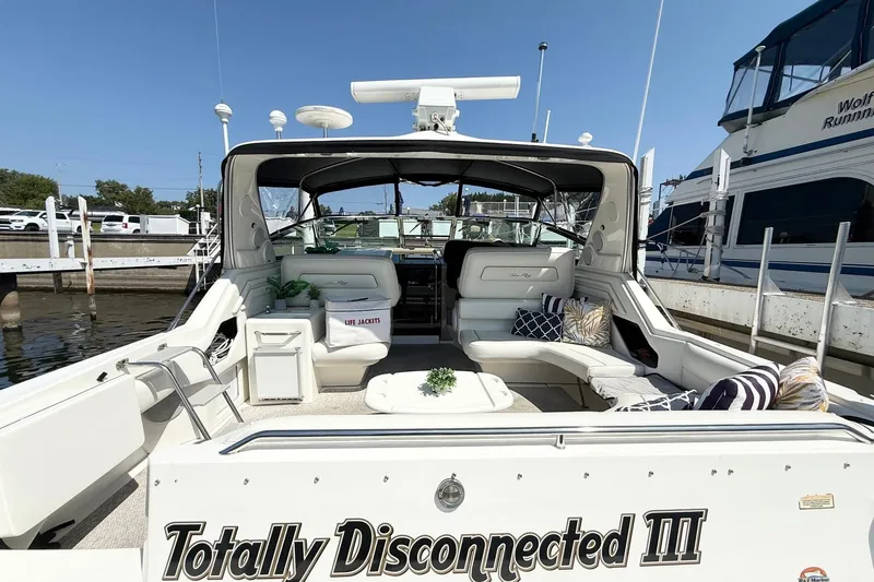 Slide: The Image of 1998 Sea Ray 400 Express Cruiser docked, featuring spacious seating and nautical decor. - 7